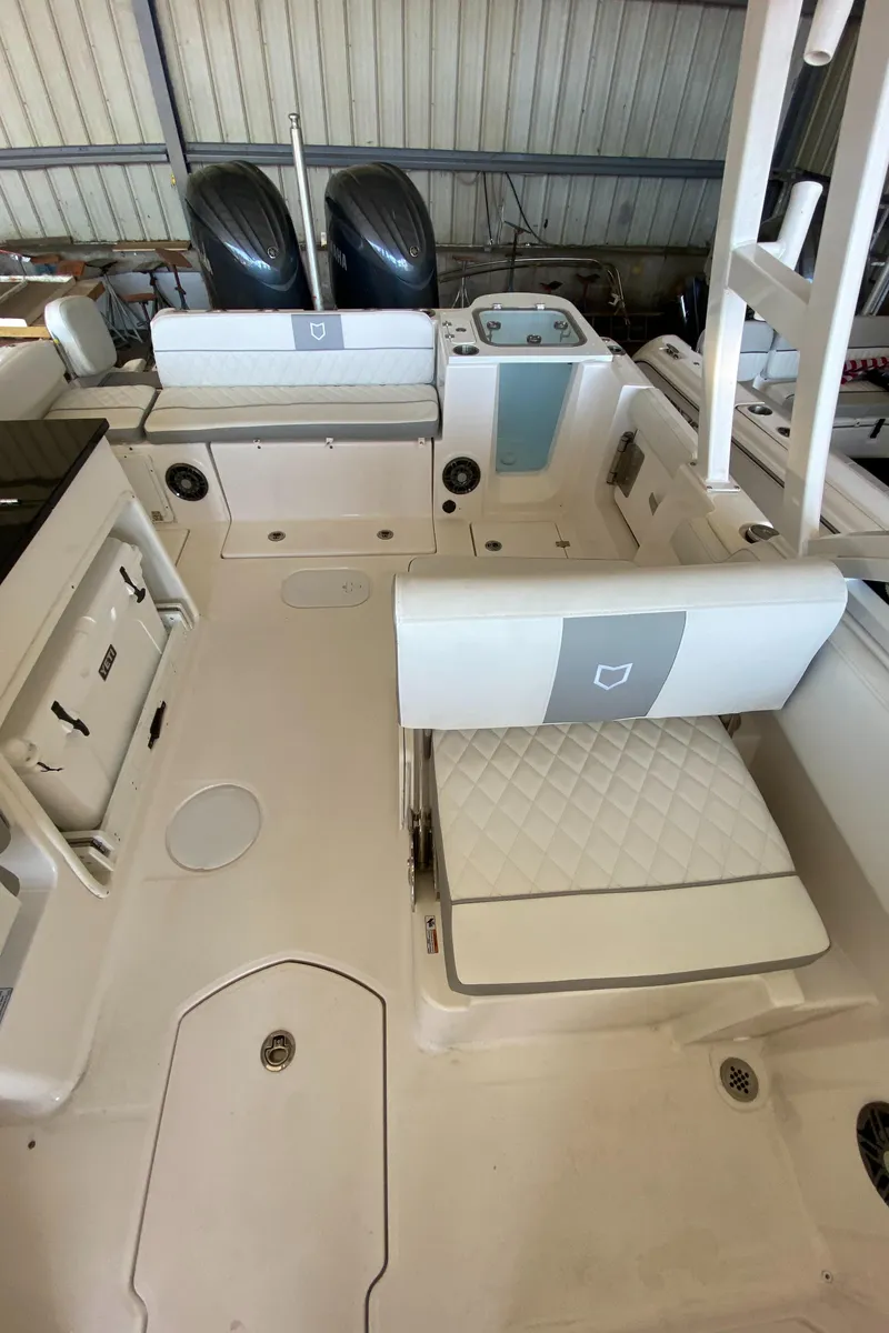 Slide: The Image of 2024 Sea Fox 268 Traveler boat interior with dual engines and seating. - 9