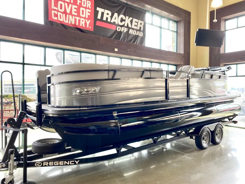 Slide: The Image of 2023 Regency 230 DL3 pontoon boat on display in showroom. - 0