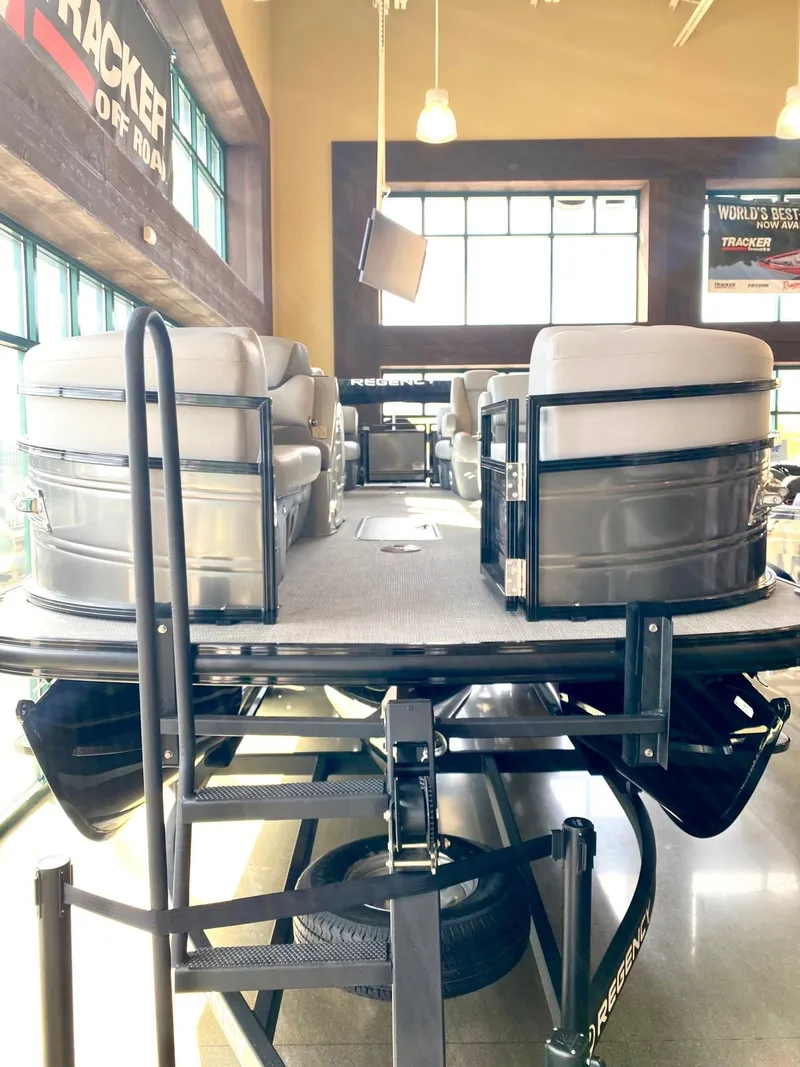 Slide: The Image of 2023 Regency 230 DL3 pontoon boat on display in showroom. - 1