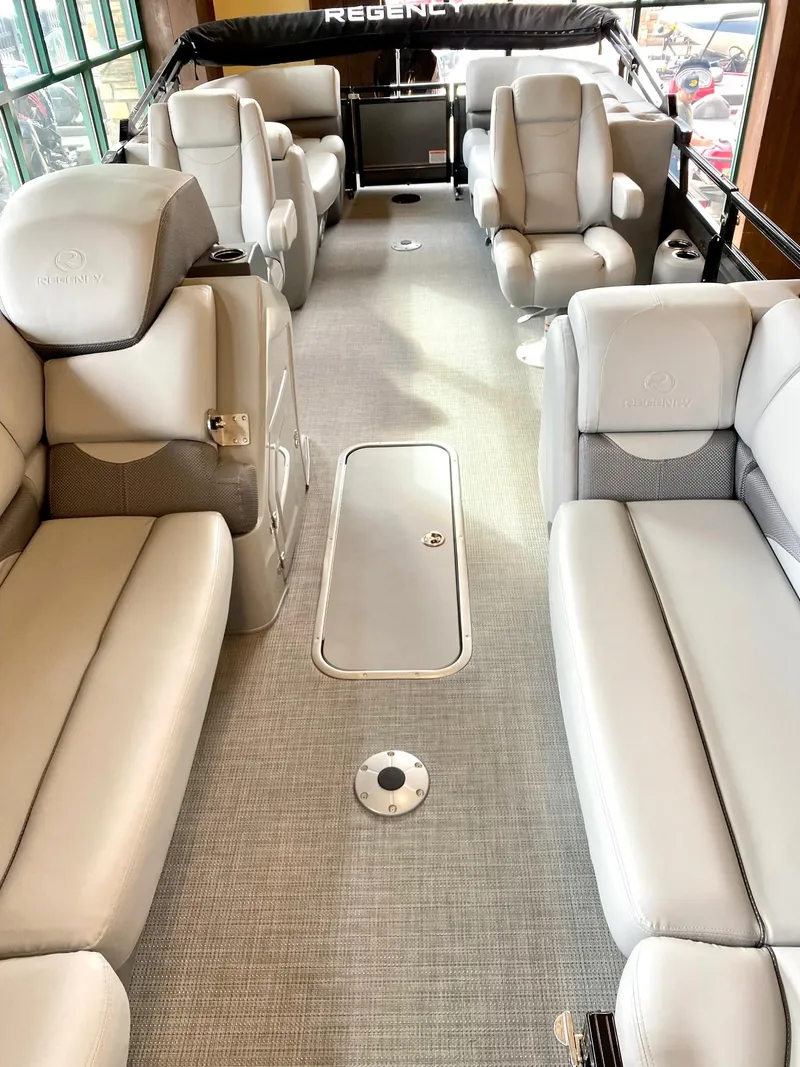 Slide: The Image of 2023 Regency 230 DL3 pontoon boat interior with luxurious seating. - 4