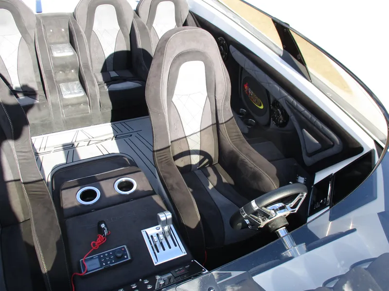 Slide: The Image of Interior of a 2015 Skater 46 speedboat with black and gray seating. - 13