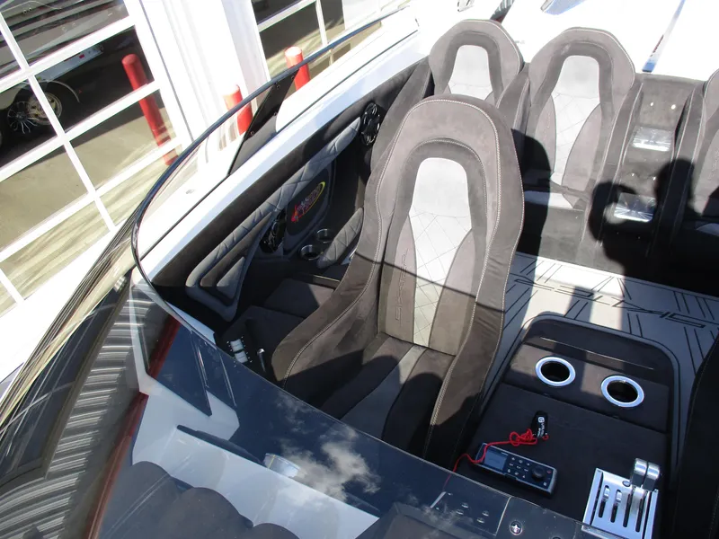 Slide: The Image of 2015 Skater 46 interior with black and gray seats, modern dashboard, and cup holders. - 14