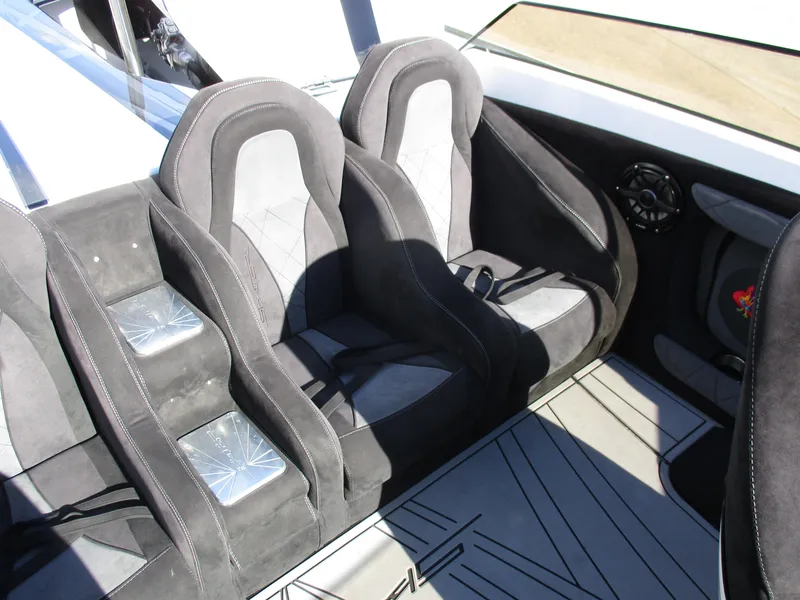 Slide: The Image of Interior seating of 2015 Skater 46 boat with black and gray upholstery. - 23