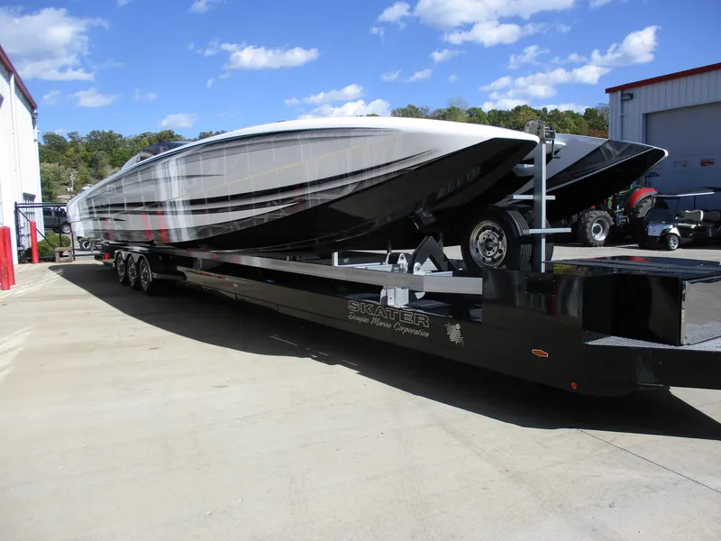 Slide: The Image of Skater 46 boat model 2015 on a trailer outside a warehouse. - 4