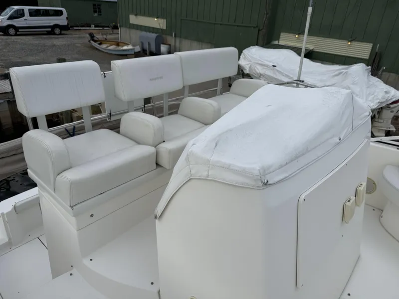 Slide: The Image of 2000 Silverton 35 Convertible boat with white seating and covered helm station. - 13