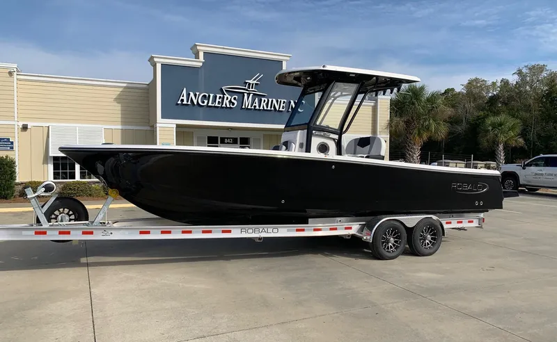 The Image of 2026 Robalo 266 Cayman boat on trailer at Anglers Marine dealership. - 0