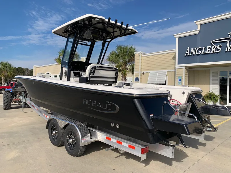 Slide: The Image of 2024 Robalo 266 Cayman boat on a trailer at Anglers Marine dealership. - 1