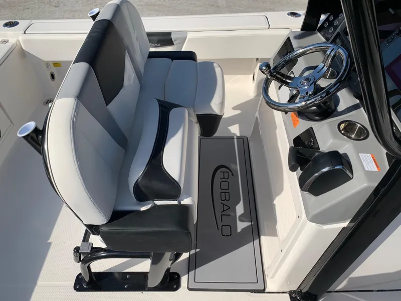 Slide: The Image of 2024 Robalo 266 Cayman boat interior with dual seats and steering console. - 12