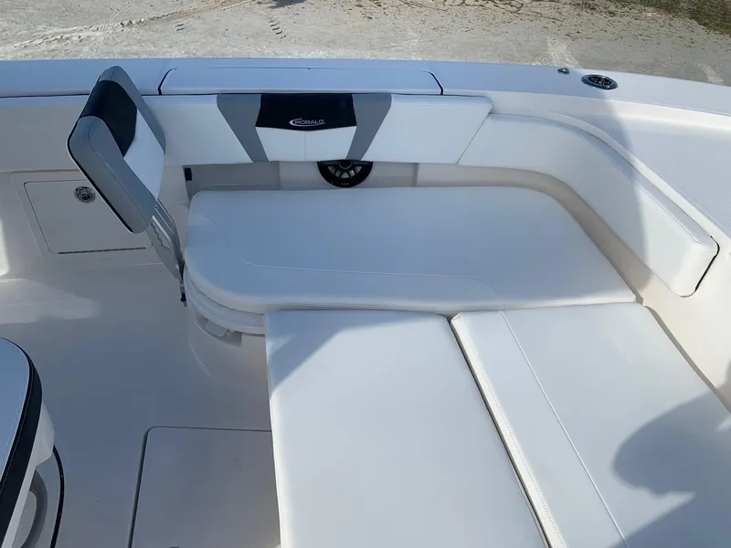 Slide: The Image of 2024 Robalo 266 Cayman boat interior seating area with white upholstery. - 19