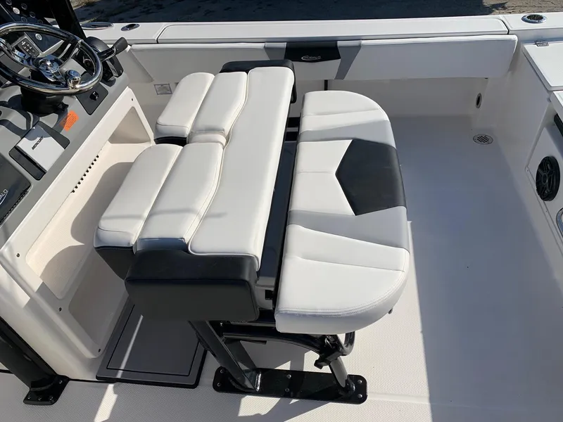 Slide: The Image of 2024 Robalo 266 Cayman boat interior with white and black cushioned seating. - 4