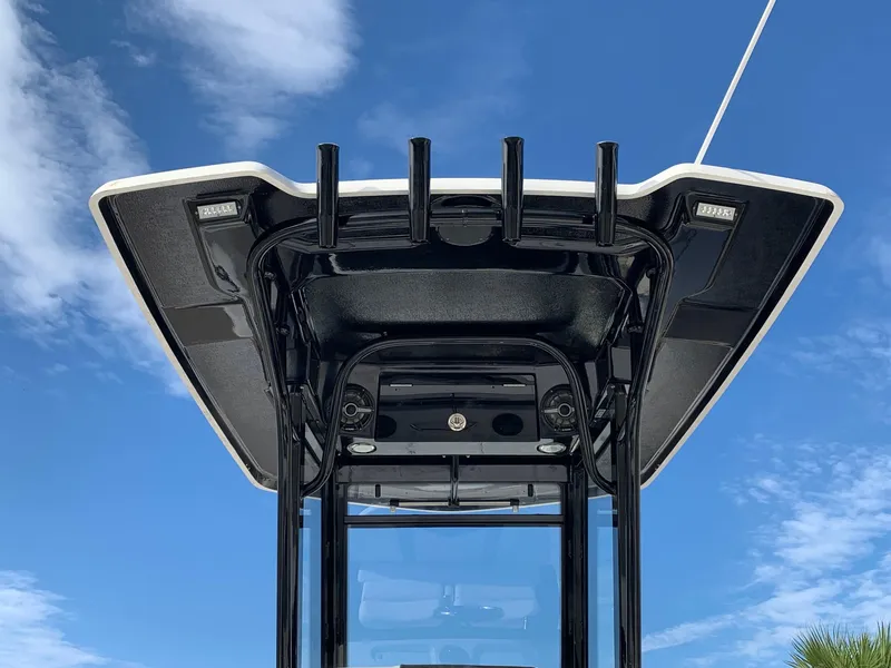 Slide: The Image of 2024 Robalo 266 Cayman boat T-top against blue sky. - 5