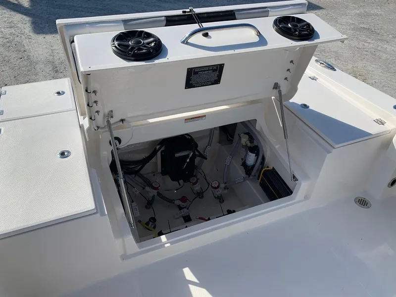 Slide: The Image of 2024 Robalo 266 Cayman boat storage compartment with open hatch and visible internal components. - 7