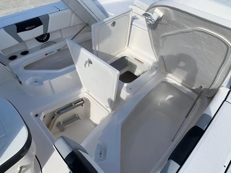 Slide: The Image of 2024 Robalo 266 Cayman boat storage compartments and seating area. - 15
