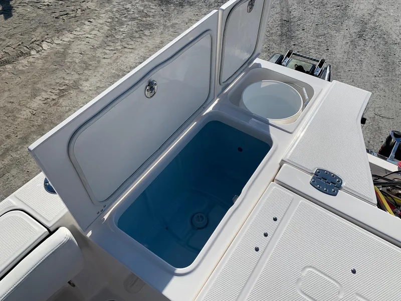 Slide: The Image of 2024 Robalo 266 Cayman boat storage compartments and livewell. - 6