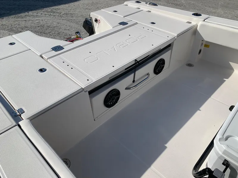 Slide: The Image of 2024 Robalo 266 Cayman boat deck with storage compartments and speakers. - 9