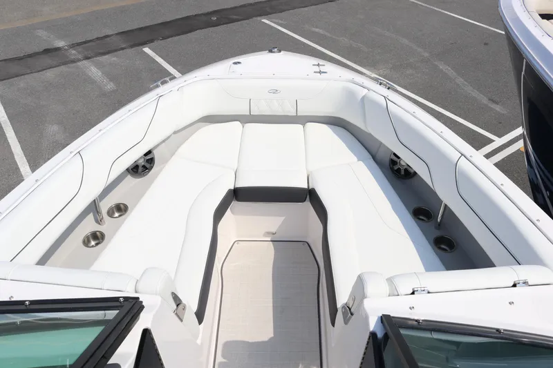 Slide: The Image of 2019 Regal LS6 boat with spacious white seating and cup holders on deck. - 12