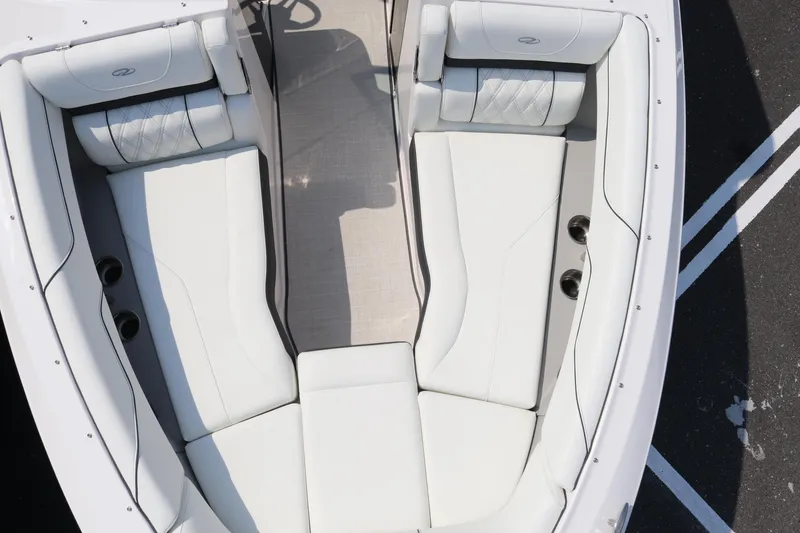 Slide: The Image of 2019 Regal LS6 boat interior with white cushioned seating and sleek design. - 13
