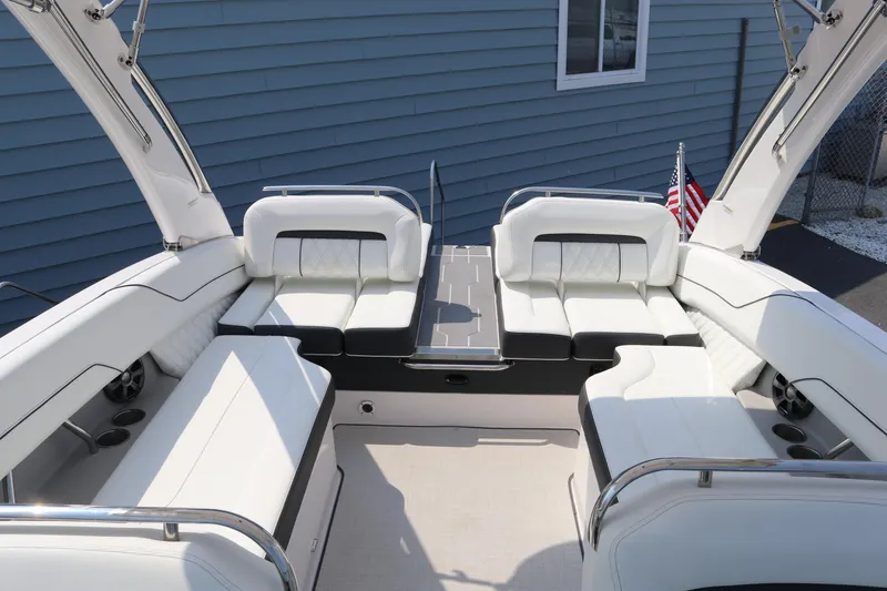 Slide: The Image of 2019 Regal LS6 boat interior with white seating and American flag. - 14