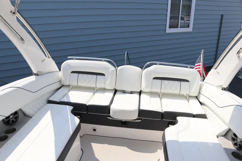 Slide: The Image of 2019 Regal LS6 boat interior with white seating and American flag. - 15