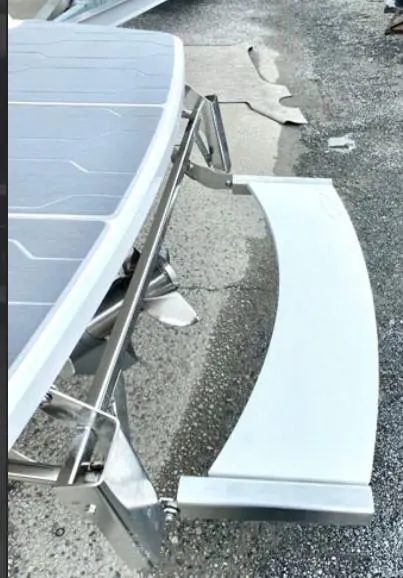 Slide: The Image of 2019 Regal LS6 boat with stainless steel swim platform on a textured surface. - 20