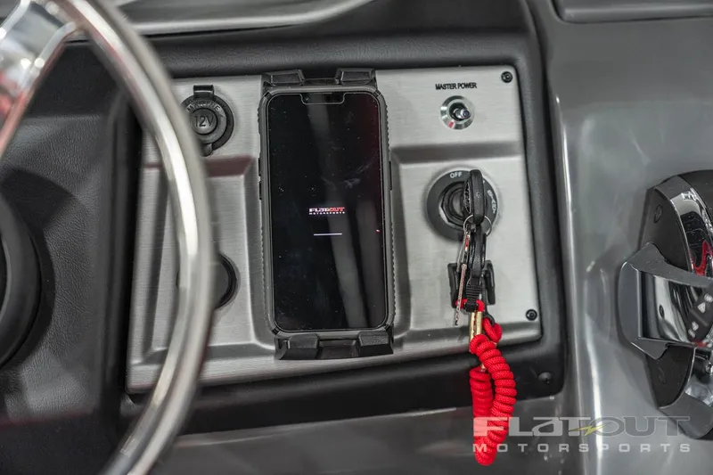 Slide: The Image of 2023 South Bay 523 RS 3.0 Plus Arch 400HP dashboard with smartphone holder and ignition switch. - 26