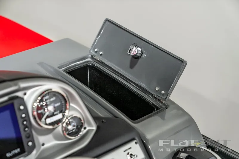 Slide: The Image of 2023 South Bay 523 RS 3.0 Plus Arch 400HP dashboard with open storage compartment. - 28