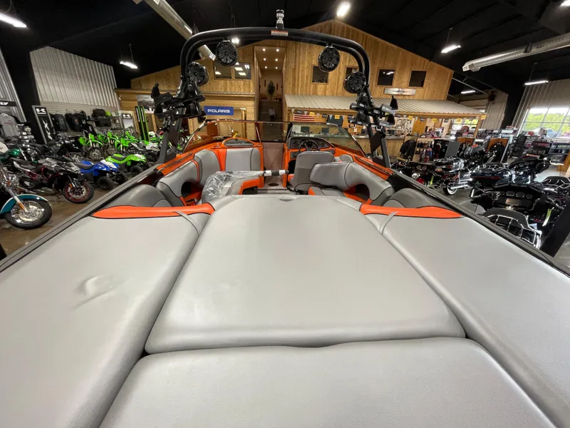 Slide: The Image of 2023 Sanger 237 SX boat interior with gray and orange seating in showroom. - 17