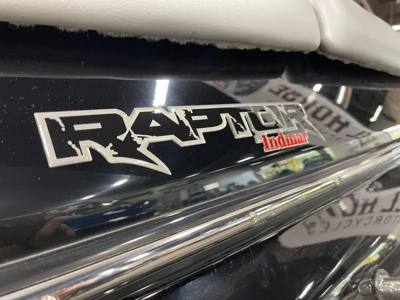 Slide: The Image of 2023 Sanger 237 SX Raptor Indmar logo on black boat exterior. - 18