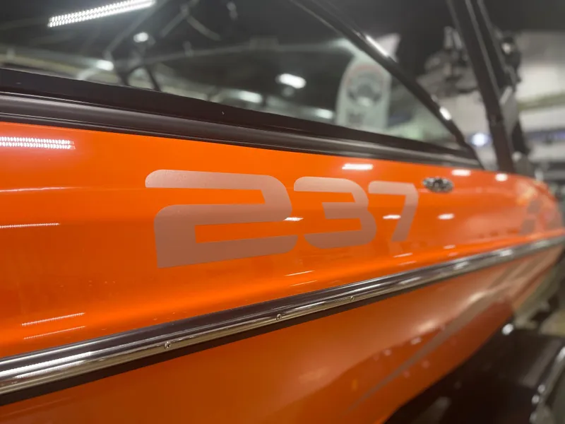 Slide: The Image of 2023 Sanger 237 SX boat, close-up of orange exterior with model number. - 5