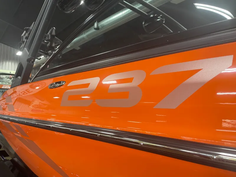 Slide: The Image of 2023 Sanger 237 SX boat, close-up of orange exterior with model number. - 7