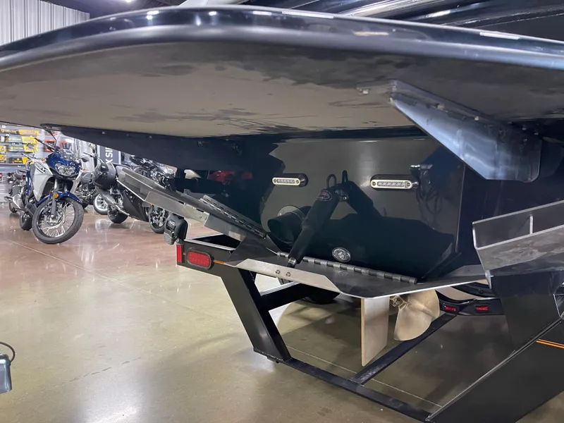 Slide: The Image of 2023 Sanger 237 SX boat on trailer in showroom. - 9