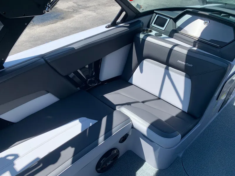 Slide: The Image of Interior seating of 2022 MasterCraft XStar S boat with black and white upholstery. - 16