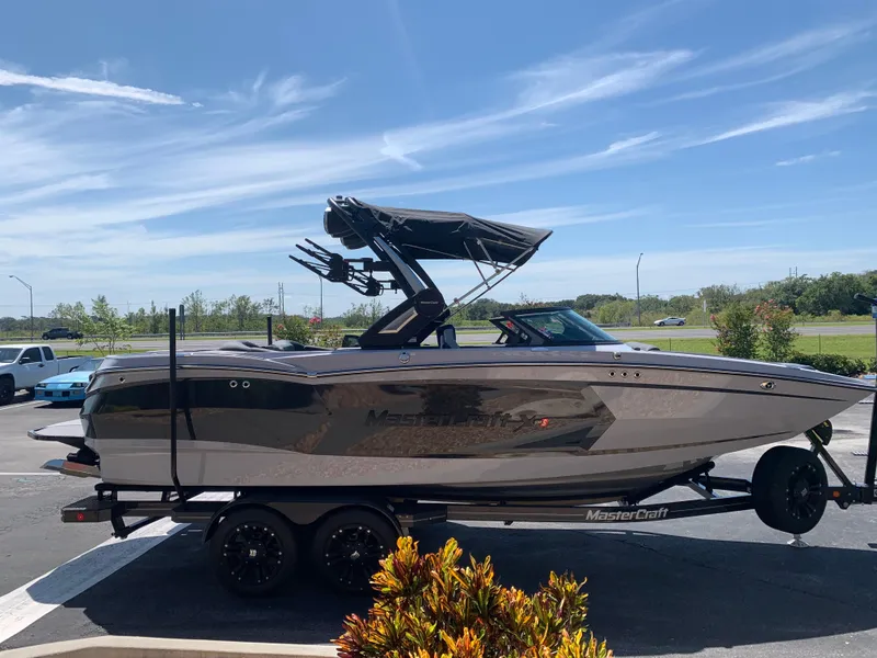 Slide: The Image of 2022 MasterCraft XStar S boat on trailer in parking lot. - 4