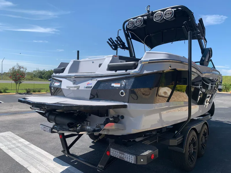 Slide: The Image of 2022 MasterCraft XStar S boat on trailer, rear view, parked outdoors. - 5