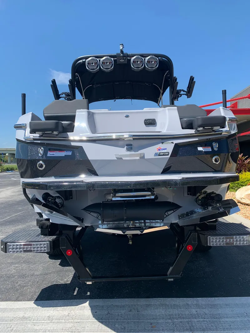 Slide: The Image of 2022 MasterCraft XStar S boat rear view with speakers and seating. - 6