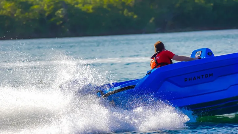 Slide: The Image of 2024 Vision Marine Technologies Phantom boat speeding on water. - 2