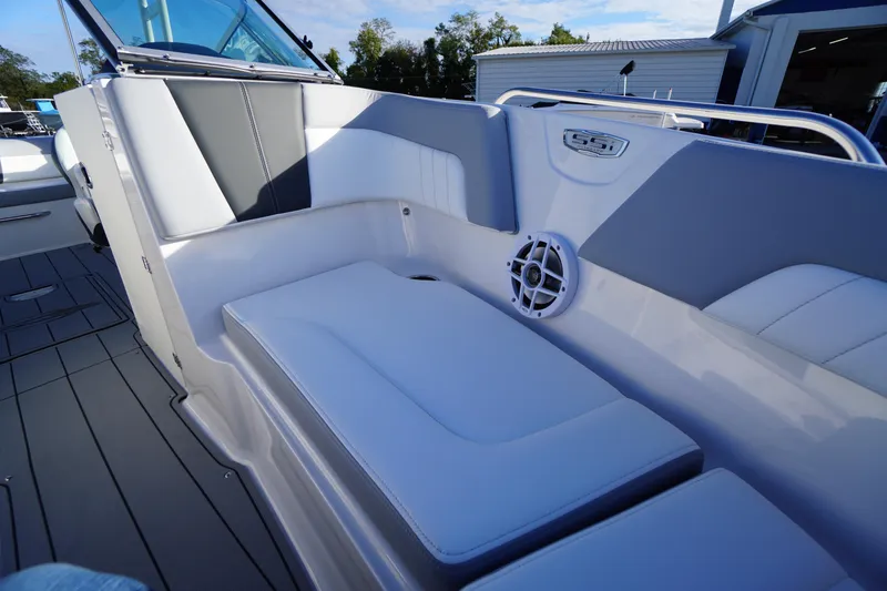 Slide: The Image of 2024 Chaparral 23 SSi OB boat interior with cushioned seating and speaker. - 13