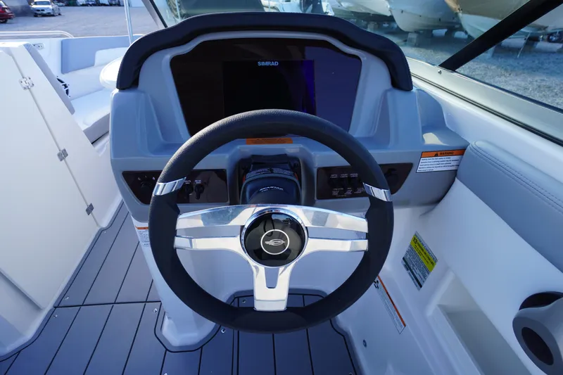Slide: The Image of 2024 Chaparral 23 SSi OB boat dashboard with steering wheel and controls. - 16