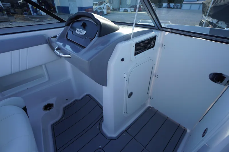 Slide: The Image of 2024 Chaparral 23 SSi OB boat interior with sleek dashboard and modern design. - 21