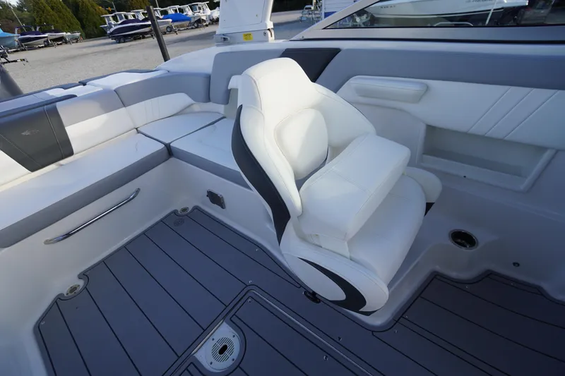 Slide: The Image of 2024 Chaparral 23 SSi OB boat interior with white seating and gray flooring. - 23