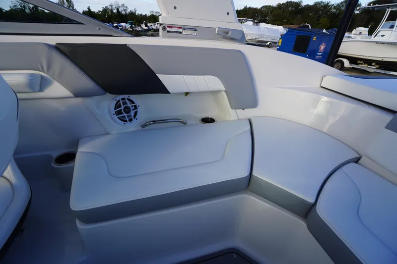 Slide: The Image of 2024 Chaparral 23 SSi OB boat interior with white seating and speaker system. - 27