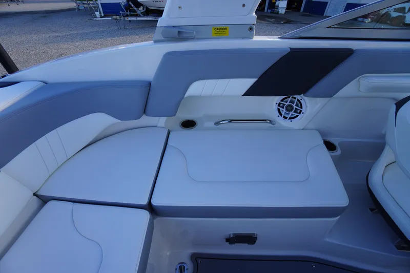 Slide: The Image of 2024 Chaparral 23 SSi OB boat interior with cushioned seating and speaker. - 30