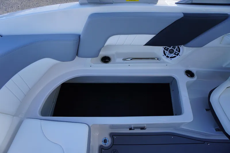 Slide: The Image of 2024 Chaparral 23 SSi OB boat interior seating with storage compartment and speaker. - 31