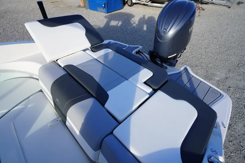 Slide: The Image of 2024 Chaparral 23 SSi OB boat with sleek seating and powerful outboard motor. - 32