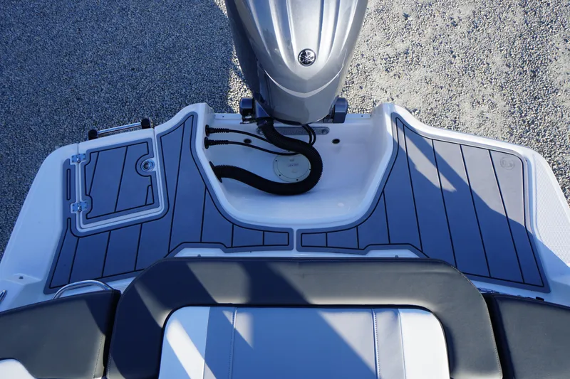 Slide: The Image of 2024 Chaparral 23 SSi OB boat deck with sleek design and modern outboard motor. - 47