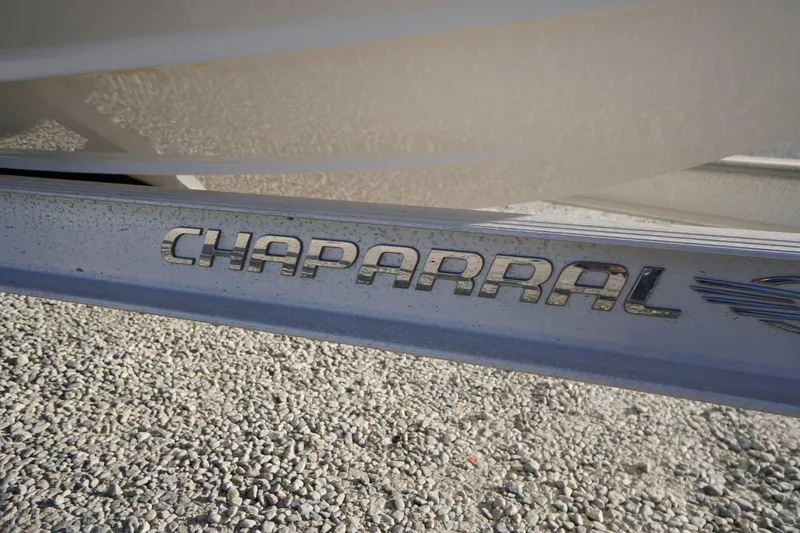 Slide: The Image of 2024 Chaparral 23 SSi OB boat logo on a metallic surface. - 50