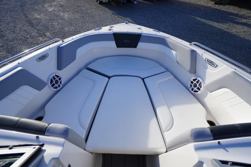Slide: The Image of 2024 Chaparral 23 SSi OB boat interior with cushioned seating and speakers. - 7