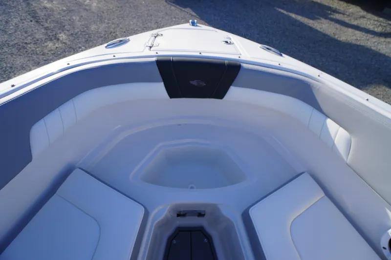 Slide: The Image of 2024 Chaparral 23 SSi OB boat interior with white seating and storage compartments. - 9