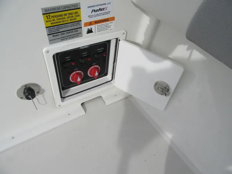 Slide: The Image of Control panel of 2023 Parker 2501 Center Console boat with open access door. - 18