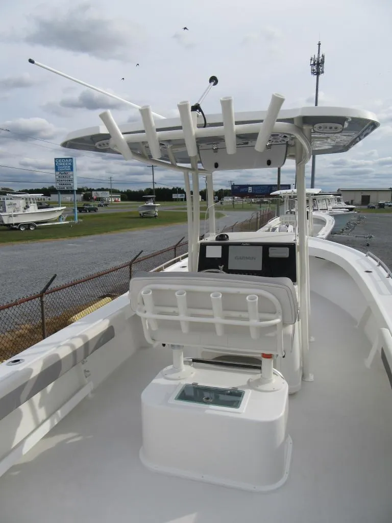 Slide: The Image of 2023 Parker 2501 Center Console boat with T-top and rod holders. - 19